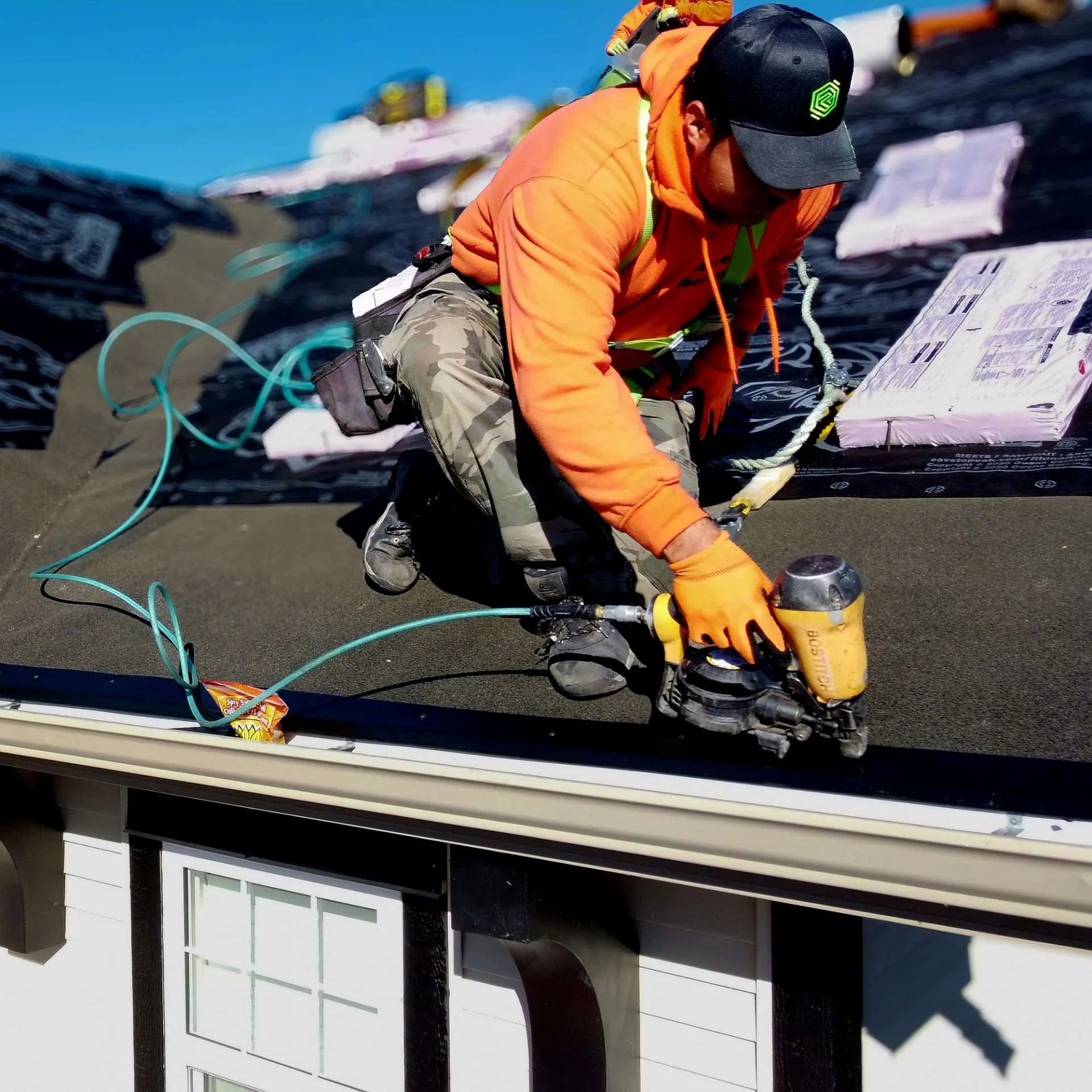 Professional InnoRoof roofing team inspecting roof components and planning residential roofing work
