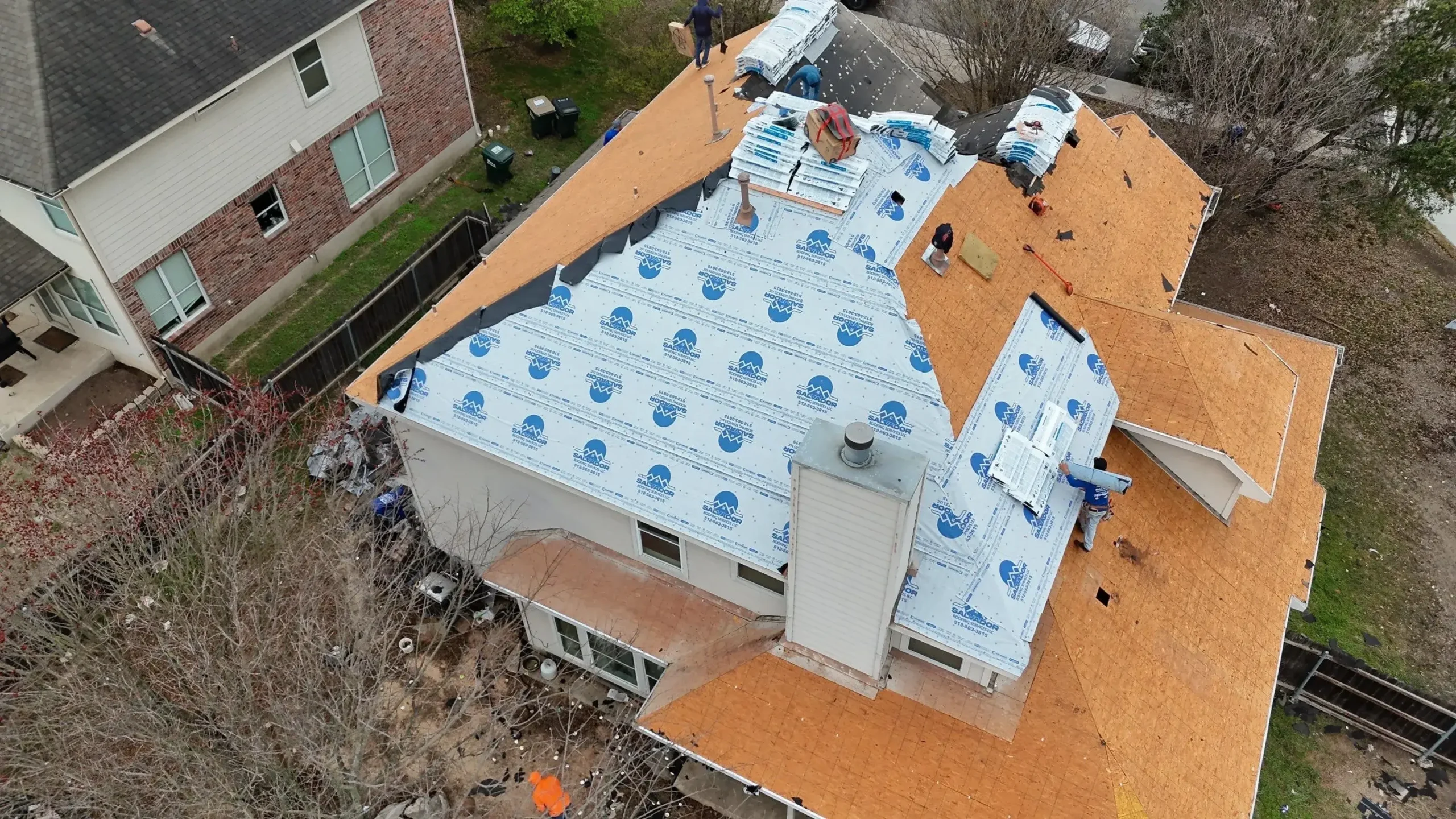 Residential roof replacement in progress with carefully aligned roofing materials and detailed installation work